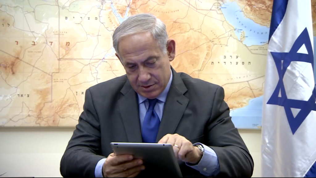 In a Rosh Hashanah greeting posted to YouTube, Israeli Prime Minister Benjamin Netanyahu plays Candy Crush. Photo: Yair Rosenberg / YouTube