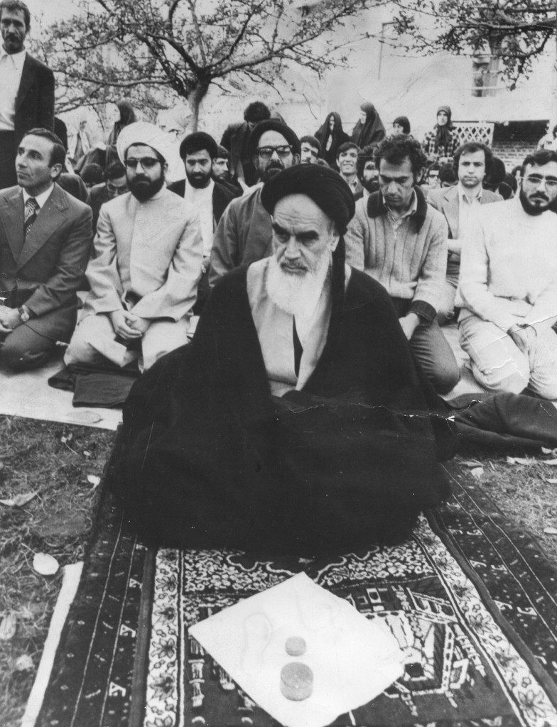 Ayatollah Khomeini praying in France. Hassan Rouhani is behind him, second from left. Photo credit: Mojtaba Salimi / Wikimedia
