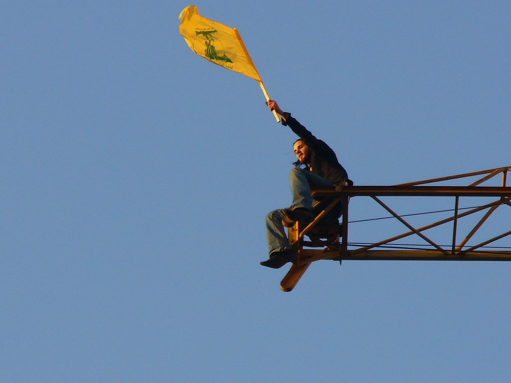 A Lebanese man waves the Hezbollah flag following the Second Lebanon War, 2006. Photo: Harout Arabian / Wikimedia