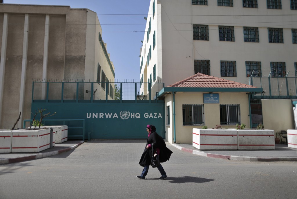 A Palestinian woman walks in front of the UNRWA building in Gaza City. Photo: Wissam Nassar/ Flash90