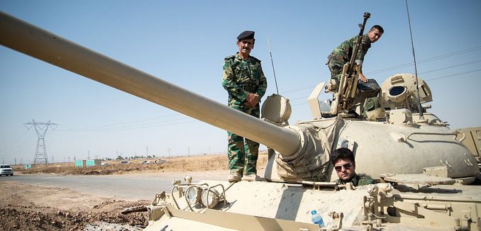 FeaturedImage_2014-08-27_WikiCommons_Peshmerga_on_a_T-55-Tank_outside_Kirkuk_in_Iraq.