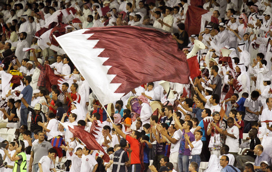 Fans cheer on their teams at a qualifying match for the 2014 World Cup between Qatar and Vietnam at Qatar's Al Sadd stadium. Photo: Vinod Divakaram / flickr