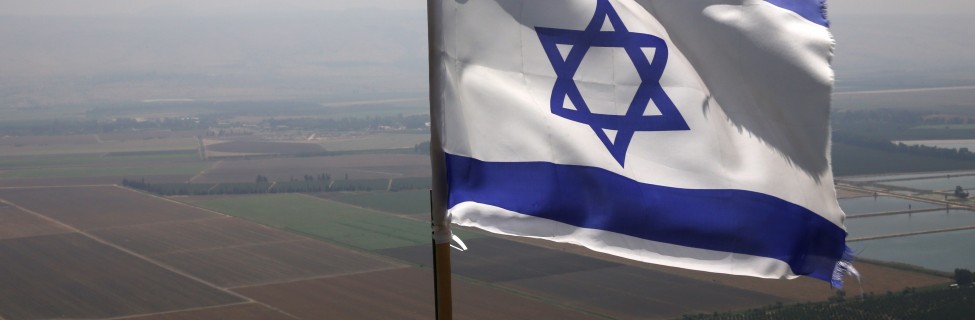 The Israeli flag waves in the wind above the northern Israeli city of Kiryat Shmona, August 13, 2014. Photo: Nati Shohat / Flash90