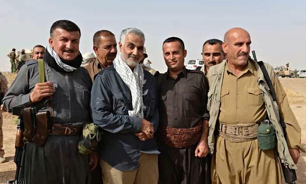 Qassem Suleimani (center, with scarf), the commander of the Iranian Revolutionary Guards Corps-Quds Force, poses with a group of peshmerga fighters in Kurdistan. Photo: Iranian television