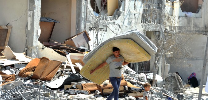 Palestinians searches through rubble
