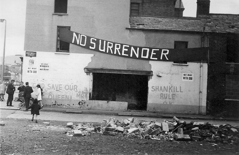 Banner and graffiti on a building in a side street off the Shankill Road, Belfast, 1970. Photo: Fribbler / Wikimedia