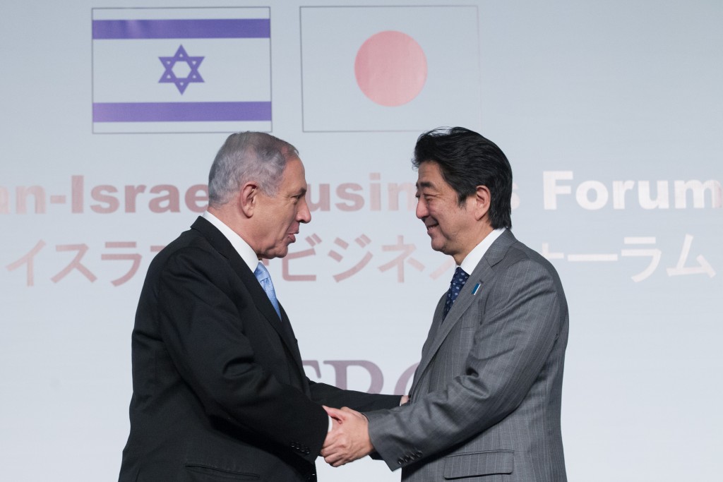 Israeli Prime Minister Benjamin Netanyahu greets his Japanese counterpart Shinzo Abe at the Japan-Israel Business Forum, held at the Waldorf Astoria Hotel in Jerusalem, January 18, 2015. Photo: Miriam Alster / Flash90