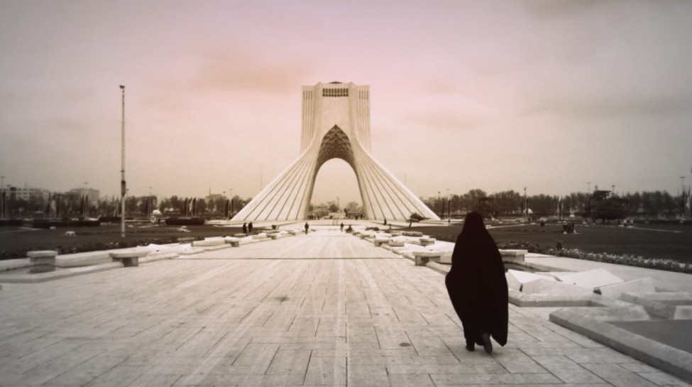 A woman walks near the Azadi Tower in Tehran. Photo: Morteza Bahmani / flickr