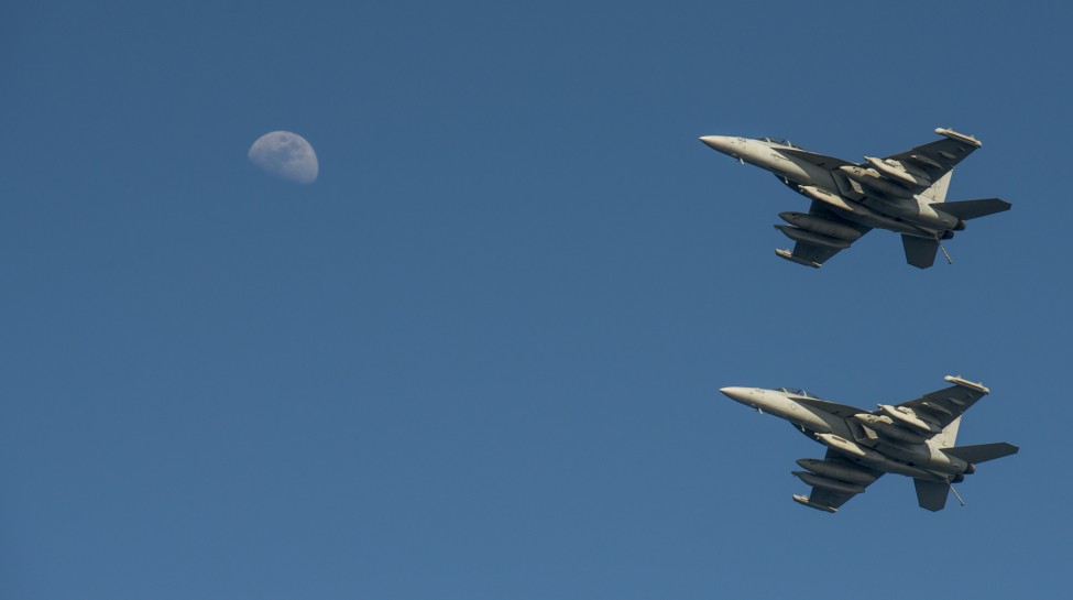 Two EA-18G Growlers fly in formation above the U.S. Navy aircraft carrier USS Carl Vinson, February 27, 2015. Carl Vinson is deployed in the U.S. 5th Fleet area of operations supporting Operation Inherent Resolve, which conducts airstrikes against ISIS targets in Iraq and Syria. Photo: MCS 2nd Class John Philip Wagner, Jr. / U.S. Navy / flickr