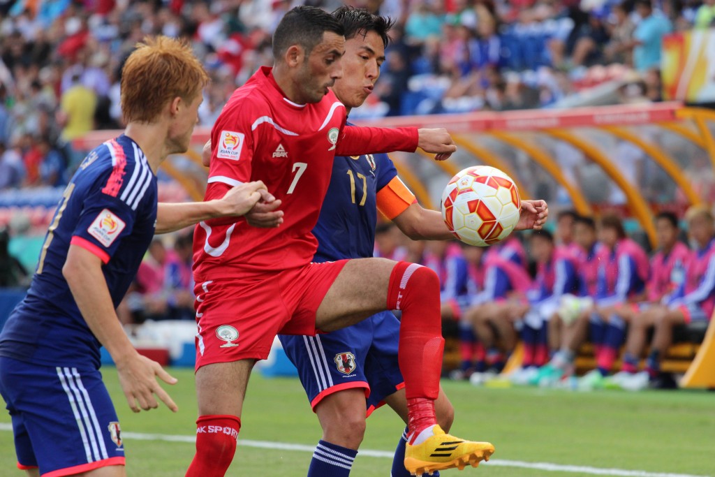 Japan takes on Palestine in a match at the 2015 Asian Cup. Photo: Nasya Bahfen / flickr