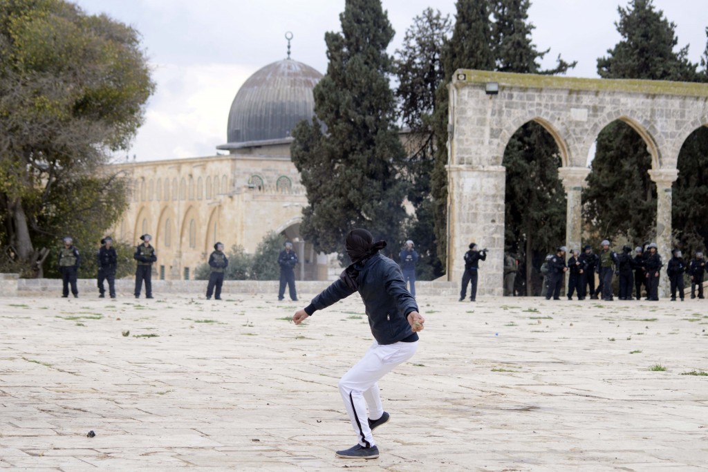 A Muslim boy throws stones at Israeli police during clashes following Friday prayers at Jerusalem's al-Aqsa mosque, December 6, 2013. Photo: Sliman Khader / Flash90