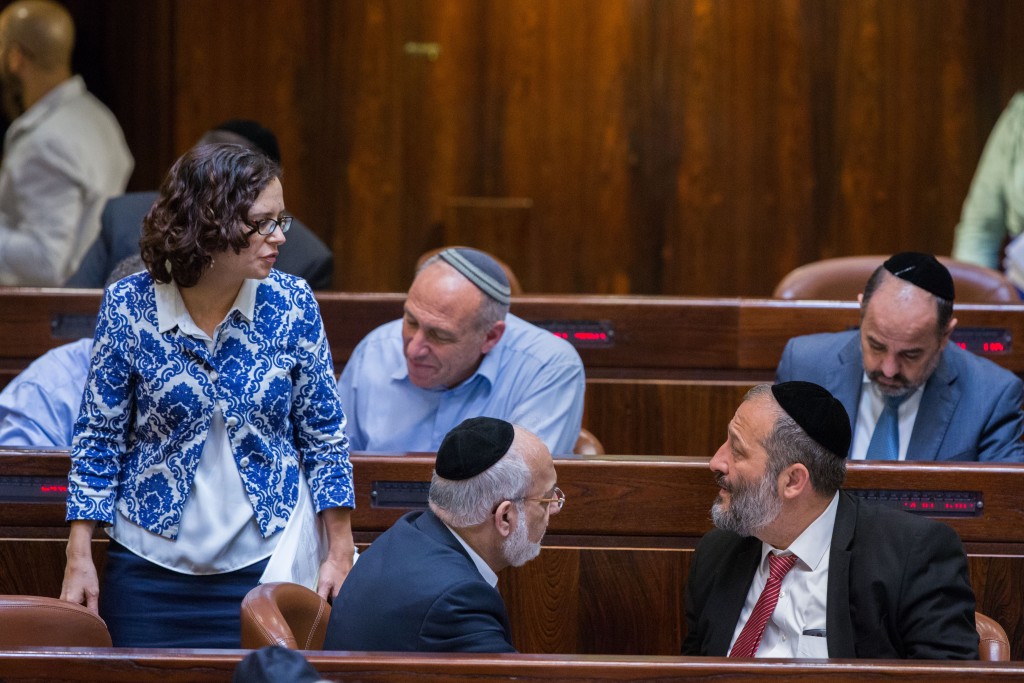 MK Rachel Azaria speaks with Economy Minister Aryeh Deri during a Knesset plenum session, July 15, 2015. Photo: Yonatan Sindel / Flash90