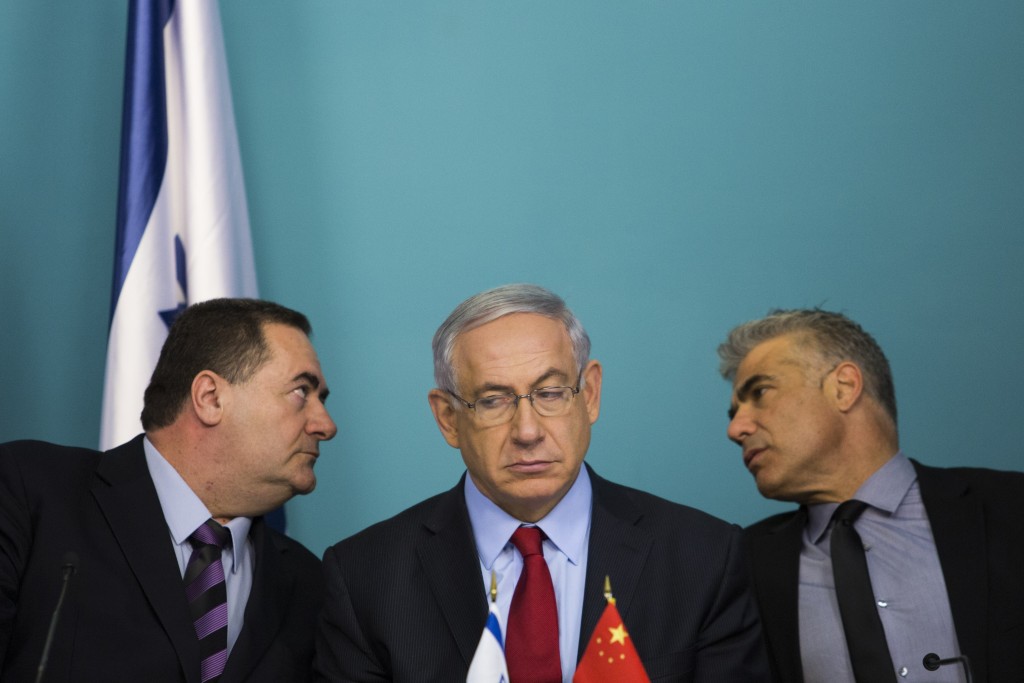 From left: Israeli Minister of Transportation Yisrael Katz, Prime Minister Benjamin Netanyahu, and Minister of Finance Yair Lapid  attend a signing ceremony at the Prime Minister's office in Jerusalem along with Chinese Ambassador to Israel Gao Yanping and Ashdod mayor Yechiel Lasri (both not seen) on September 23, 2014. After three months of negotiations, Israel and the China Harbor Engineering Company have reached terms for the Beijing firm to begin construction on a private port in Ashdod. Photo: Noam Revkin Fenton/Flash90