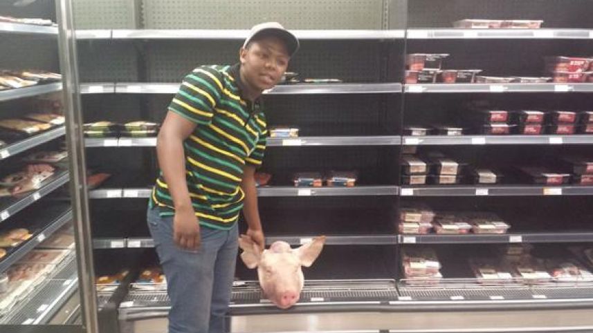 An anti-Israel activist places a pig’s head in the kosher section of a Cape Town supermarket. Photo: Twitter