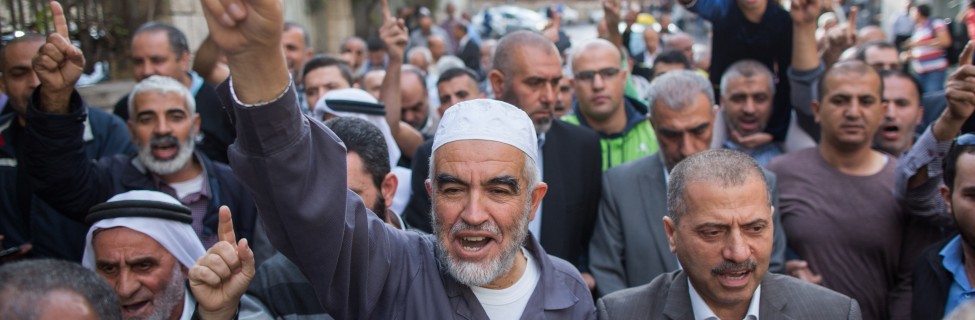 Sheikh Raed Salah, the leader of the Northern Branch of the Islamic Movement , marches with his supporters outside the Jerusalem District Court, October 27, 2015. Salah recieved a sentence of eleven months in prison for incitement to violence and racism against Jews. Photo: Yonatan Sindel / Flash90