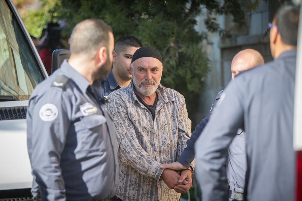 Left-wing Israeli activist Ezra Nawi, surrounded by Israeli prison guards, arrives at the Jerusalem Magistrate's Court, January 12, 2015. Nawi was arrested at Ben-Gurion airport as he tried to leave the country. He is accused of conspiracy to commit a crime. Photo: Yonatan Sindel / Flash90