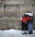 Worshipers pray amid snowfall at the Western Wall. Photo: Hadas Parush / Flash90