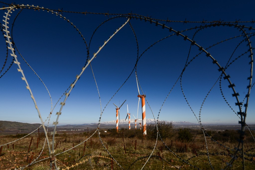 Windmills seen through barbed wire in northern Israel near the Syrian border, February 3, 2016. Photo: Mendy Hechtman / Flash90