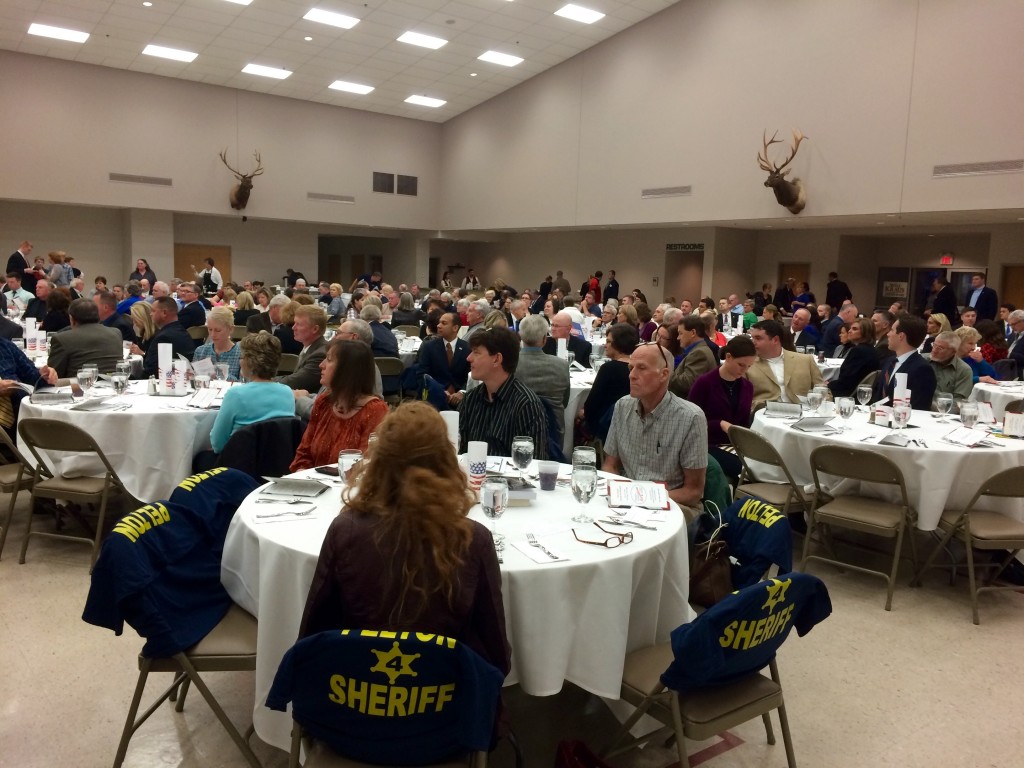 Lincoln Day attendees advertise their choice for county sheriff. Photo: Miriam Pollock / The Tower