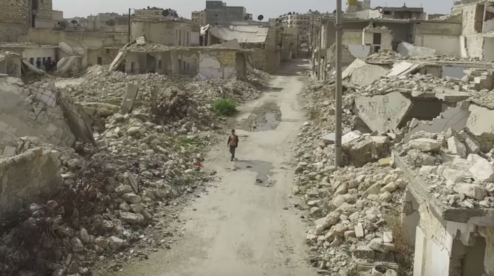 A boy walks through the ruins of Aleppo. Photo: BBC News / YouTube