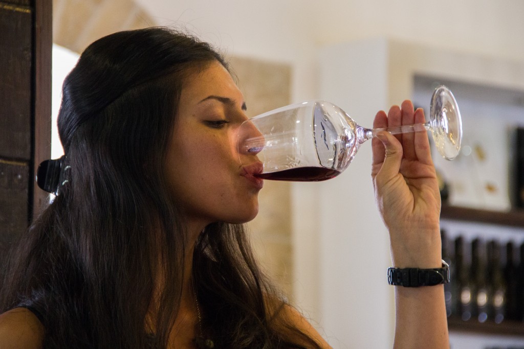 A young woman sips from her glass of wine at the Psagot winery in the West Bank. Photo: Garrett Mills / Flash90
