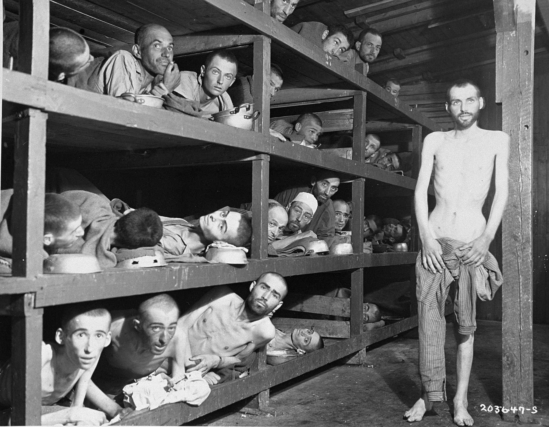 Elie Wiesel in Buchenwald; Wiesel is seen in the second row of bunks, seventh from the left, next to the vertical beam. [Photo: US Holocaust Memorial Museum]