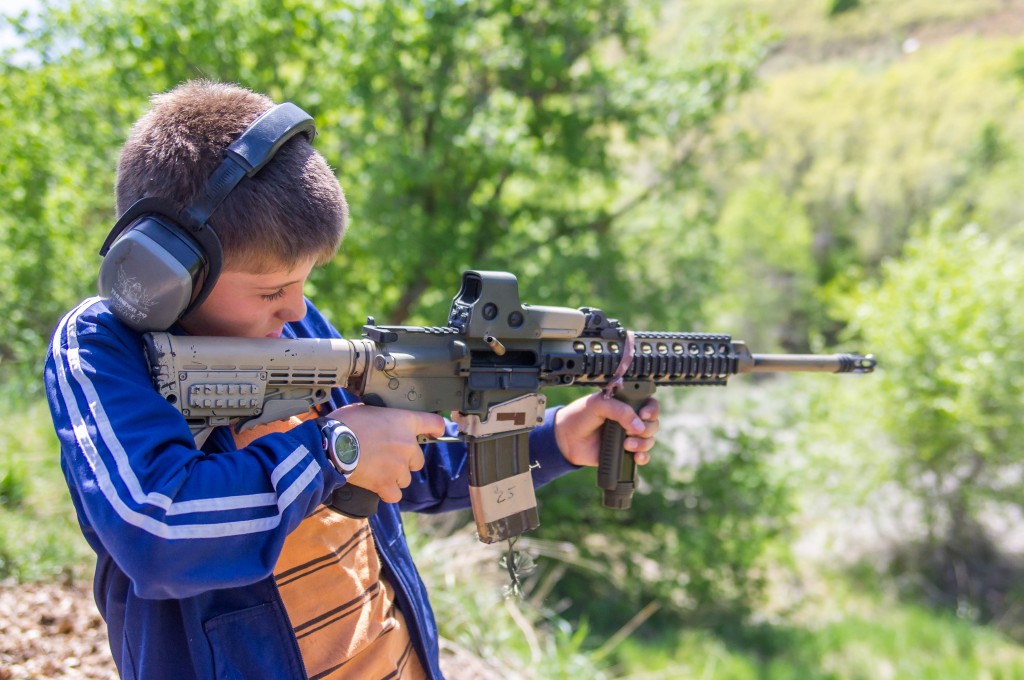 A child in Utah fires an AR-15 assault rifle. Photo: William Wootton / flickr