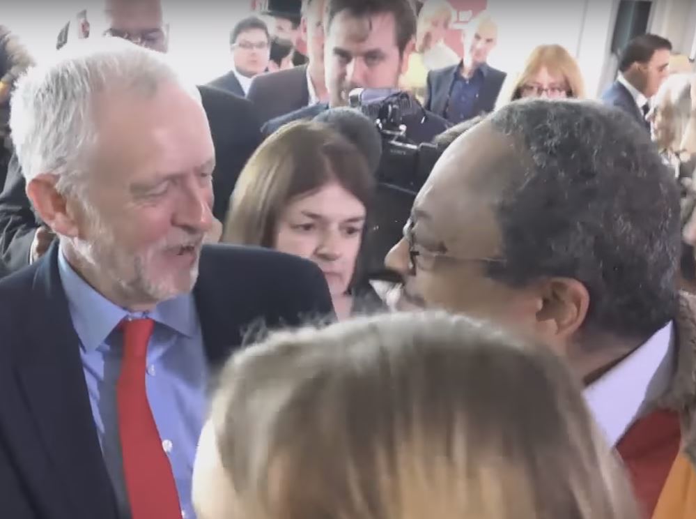 Jeremy Corbyn shakes the hand of Labour Party activist Marc Wadsworth, shortly after Wadsworth accused a Jewish member of parliament of being part of a media conspiracy at the unveiling of Labour’s report on anti-Semitism in the party. Photo: Ruptly TV / YouTube