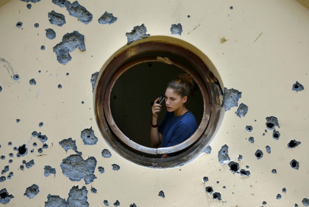 An Israeli woman checks the damage to her house after a Katyusha-style rocket attack in the northern Israeli town of Karmiel, July 15,  2006. Photo: Pierre Terdjman / Flash90