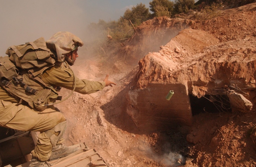 An Israeli soldier tosses a grenade into a Hezbollah bunker. Photo: Israel Defense Forces