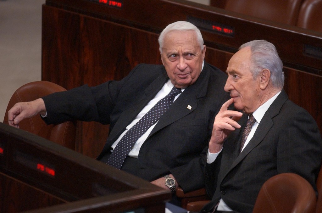 Prime Minister Ariel Sharon sits with Shimon Peres in the Knesset, January 2005. Photo: Sharon Perry / Flash90