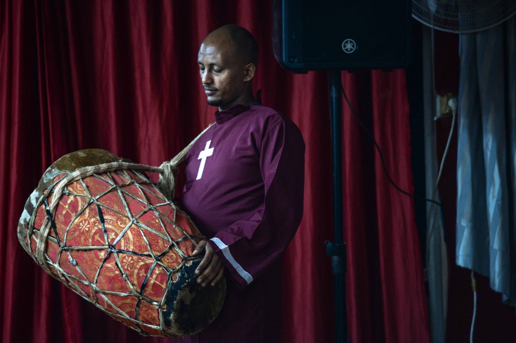 Members of the Eritrean Christian community often incorporate drumming in their services. Photo: Aviram Valdman / The Tower