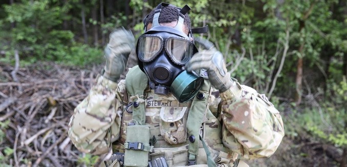 U.S. Army Sgt. Jimmy Lee Stewart of Alpha Company, 3rd Brigade Support Battalion, 1st Armored Brigade Combat Team, 3rd Infantry Division puts on his gas mask while conducting a complex attack during exercise Combined Resolve IV at the U.S. Army’s Joint Multinational Readiness Center in Hohenfels, Germany, May 22, 2015.  Combined Resolve IV is an Army Europe directed exercise training a multinational brigade and enhancing interoperability with allies and partner nations. Combined Resolve trains on unified land operations against a complex threat while improving the combat readiness of all participants. The Combined Resolve series of exercises incorporates the U.S. Army’s Regionally Aligned Force with the European Activity Set to train with European Allies and partners. The 7th Army JMTC is the only training command outside the continental United States, providing realistic and relevant training to U.S. Army, Joint Service, NATO, allied and multinational units, and is a regular venue for some of the largest training exercises for U.S. and European Forces. (U.S. Army photo by Spc. Shardesia Washington/Released)