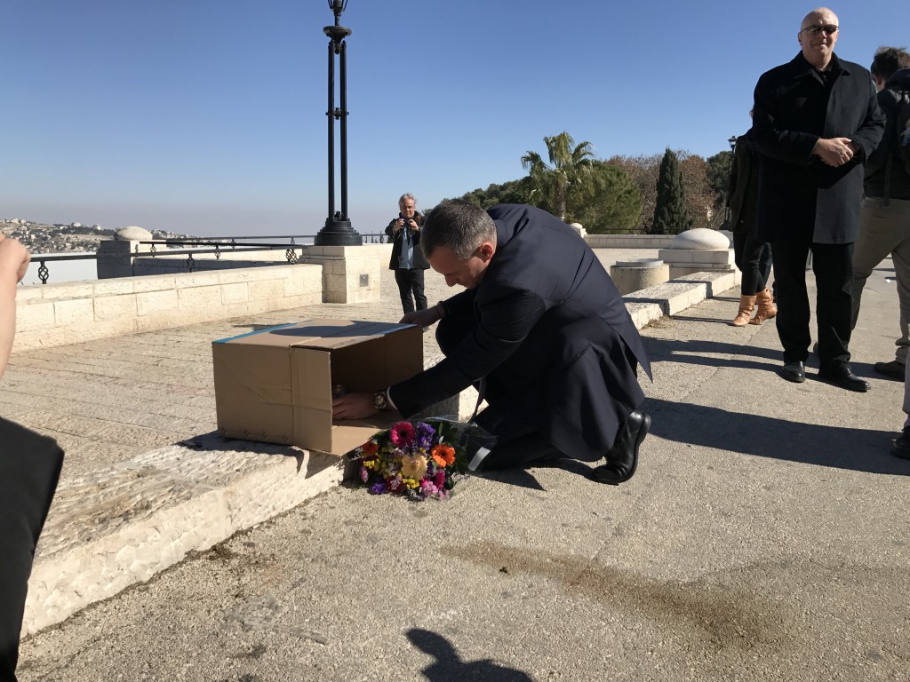 UN Special Coordinator for the Middle East Peace Process, Nickolay Mladenov, lights a candle at the site of Sundays terror attack in Jerusalem, at a memorial hosted by The Israel Project.
