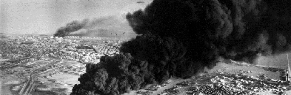  Smoke rises from oil tanks beside the Suez Canal hit during the initial Anglo-French assault on Port Said, November 5, 1956. Photo: Imperial War Museum