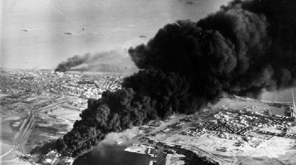  Smoke rises from oil tanks beside the Suez Canal hit during the initial Anglo-French assault on Port Said, November 5, 1956. Photo: Imperial War Museum