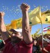 Hezbollah supporters shout slogans and wave Hezbollah flags, during a rally commemorating "Liberation Day" which marks the withdrawal of the Israeli army from southern Lebanon in 2000, in the southern border town of Bint Jbeil, Lebanon, Sunday May 25, 2014. Hezbollah's leader Sheik Hassan Nasrallah is warning that hard-line foreign fighters in Syria pose a global threat as they return home. Nasrallah accused European countries of easing the flight of extremist fighters into Syria, where they are fighting against the rule of President Bashar Assad. (AP Photo/Hussein Malla)